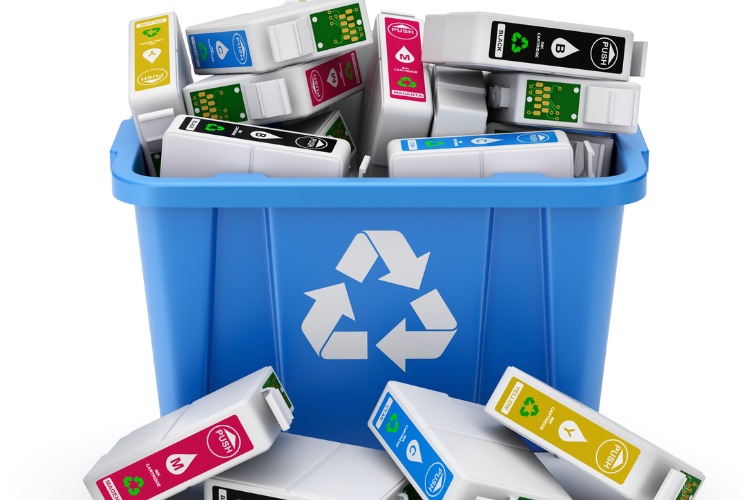Recycling bin full of empty printer cartridge containers to signify the importance of recycling.