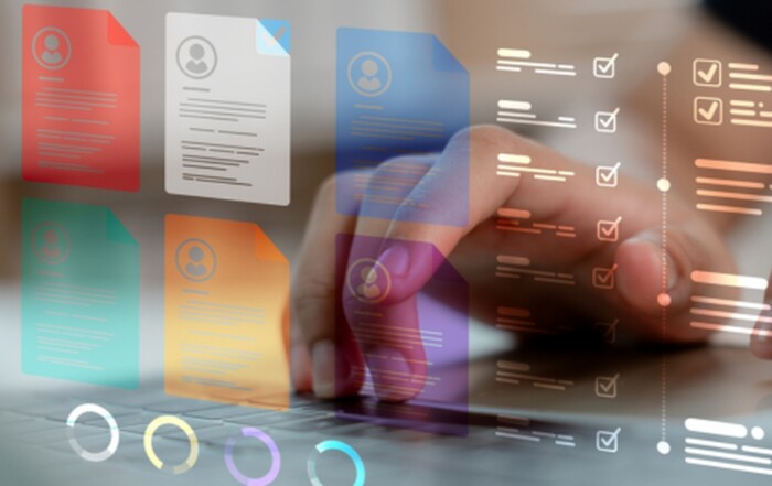 Hand selecting digital document files and checklists on a laptop, showing automated document management workflows.