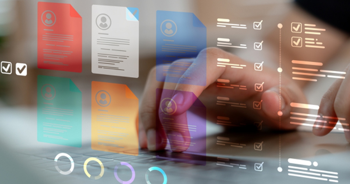 Hand selecting digital document files and checklists on a laptop, showing automated document management workflows.